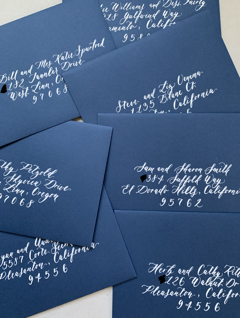 white calligraphy on blue envelopes