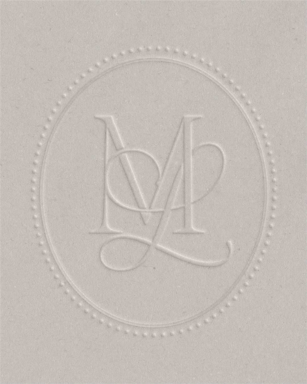 Script and serif monogram brand mark with oval border